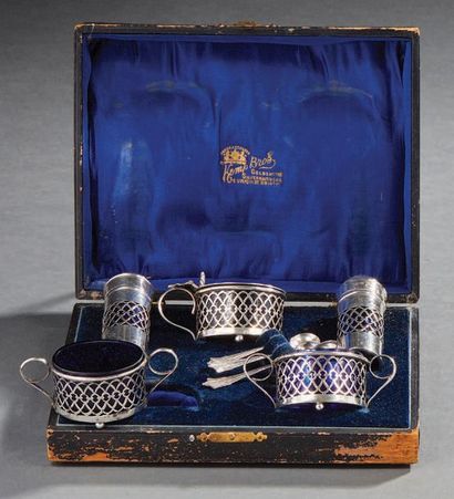 null Box containing four salt shakers and a silver mustard pot, cobalt blue glassware.
English...