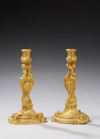 null PAIR OF CANDLES in chased and gilded bronze; bobèches supported by three young...