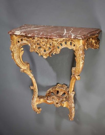 null Sculpted and gilded oak CONSOLE; the pierced belt centered with a shell; double...