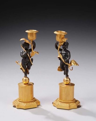 null PAIR OF CANDLES in chased, gilded or patinated bronze in the form of a Cupid...