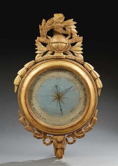 null BAROMETER in gilded and carved wood in a circular shape surmounted by an openwork...