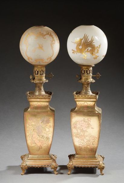 null PAIR OF OIL LAMPS in bronze and brass and copper, the body in the form of a...
