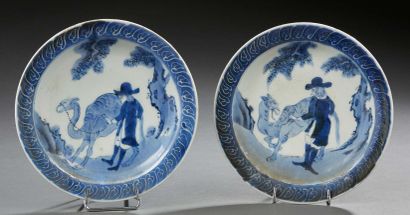 CHINE Two circular porcelain cups decorated in blue with foreign (Dutch?) characters...