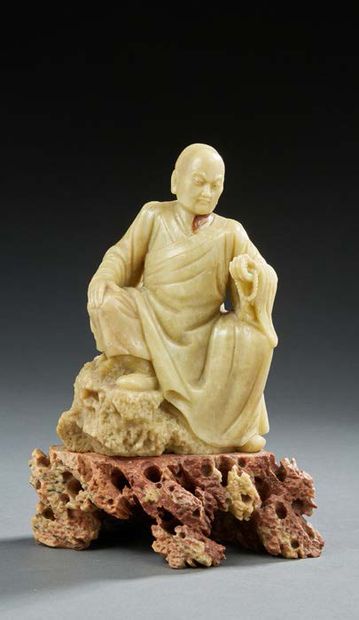 CHINE Carved soapstone figurine representing a LOHAN sitting on a brown base representing...