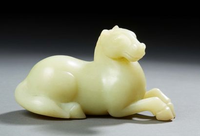 CHINE Figurine en jade jaune sculpté représentant un cheval couché.
Vers 1900.
Long....