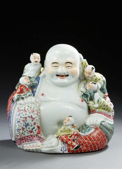 CHINE Large porcelain Buddha sitting surrounded, with five children perched, the...