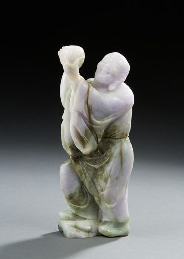 CHINE Two carved hard stone figurines. One representing a figure holding a carp in...