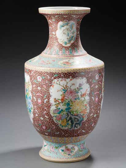 CHINE A large porcelain baluster vase decorated in famille rose enamels with branches...