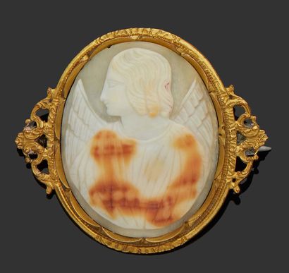 null A gilded metal brooch with a shell cameo representing an angel profile.
H. :...