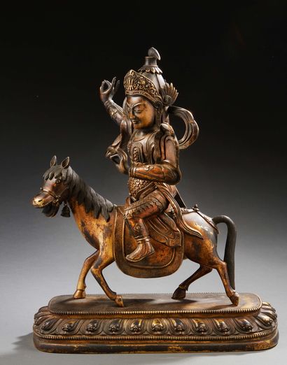 STYLE SINO-TIBÉTAIN 
A bronze group with a brown and gilded patina representing a...