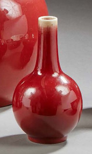 CHINE 
A small long narrow-necked porcelain bottle vase with monochrome oxblood glaze.
19th...