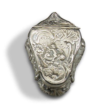 null A chased and embossed silver TOBACCO BOX decorated with a putto straddling a...