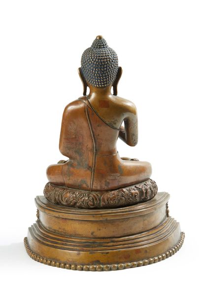 CHINE A bronze Buddha with a medallic patina in the padmasana position and performing...