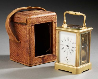 null A brass TRAVEL CLOCK; of terminal form with bevelled glass fronts; the main...