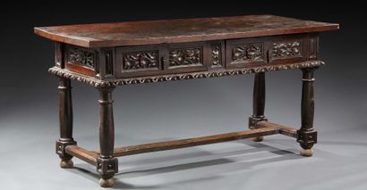 null A walnut table, moulded or turned; the crosspieces are carved with foliage friezes...