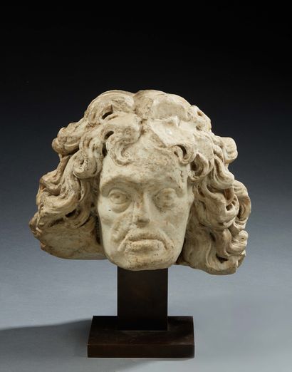 null HEAD OF A MAN in marble sculpted in the round; hair with strongly wavy strands...