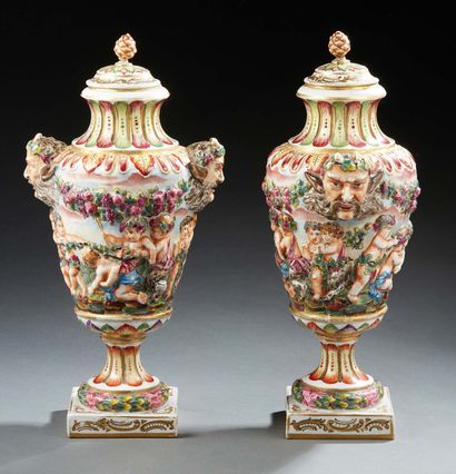 null A PAIR OF COVERED VASES in polychrome porcelain; the grips of the lid in pine...