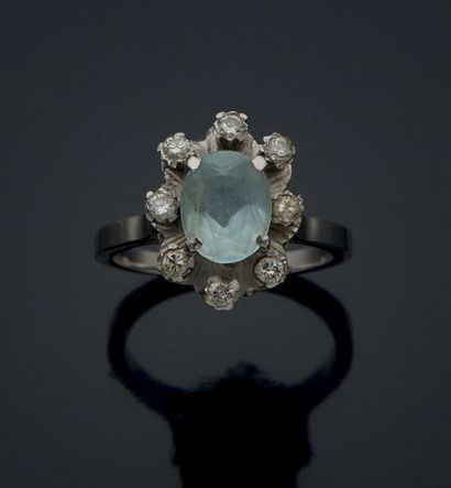 null MARGUERITE RING in white gold 750 mm, set with an oval topaz in a circle of...