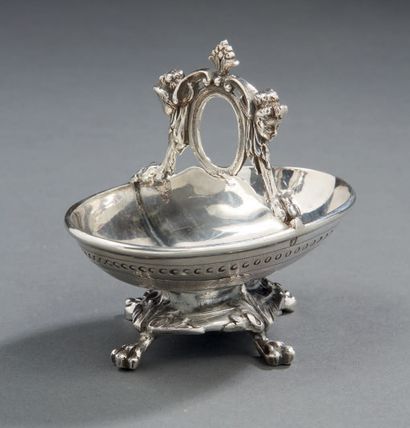 null A silver DOUBLE SALON in the shape of a basket. It rests on four legs formed...