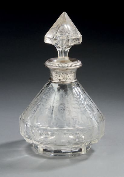 null A finely engraved crystal JUG, the silver frame chased and gadrooned.
Minerve...