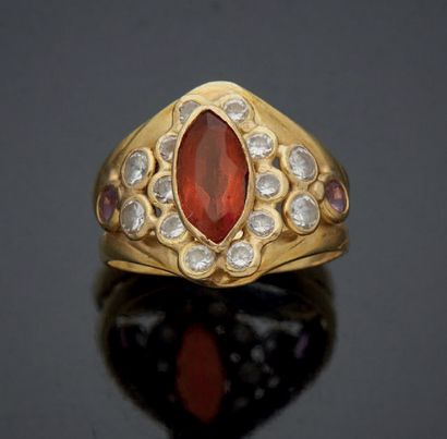null A large openwork ring set with a navette-cut citrine surrounded by small brilliant-cut...