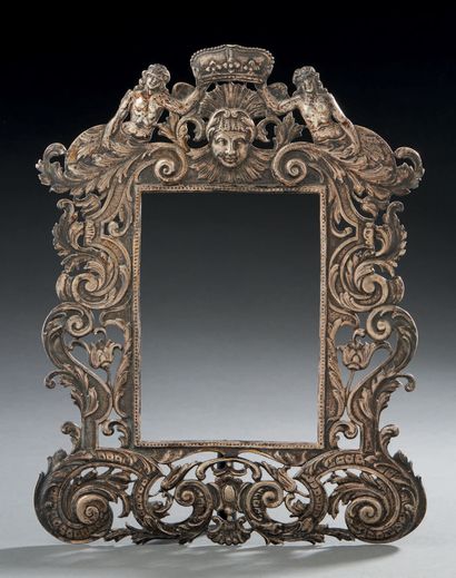 null A silver repoussé FRONTIER FRAME decorated with foliage, nymphs and a mascaron...
