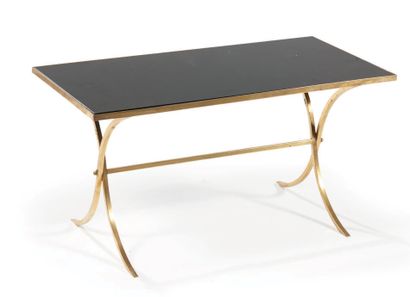 TRAVAIL FRANÇAIS Gilded brass coffee table with a rectangular black glass top resting...