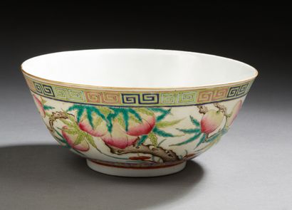 CHINE A circular porcelain bowl decorated in famille rose enamels with branches of...