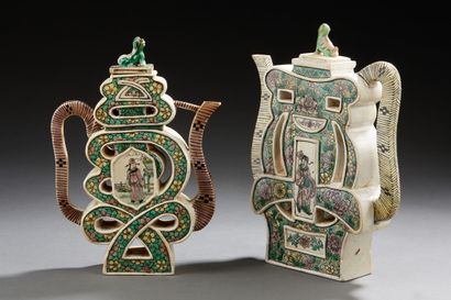 CHINE Two enamelled biscuit wine pourers in green family enamels of openwork form...