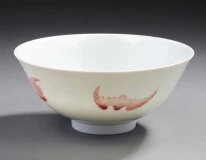 CHINE A circular porcelain bowl decorated in copper red with four bats. On the reverse...