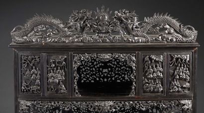 CHINE A richly carved and openworked fruitwood cabinet. The whole is decorated with...