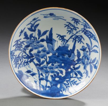 CHINE Circular porcelain bowl decorated in blue underglaze with two birds on a rock...