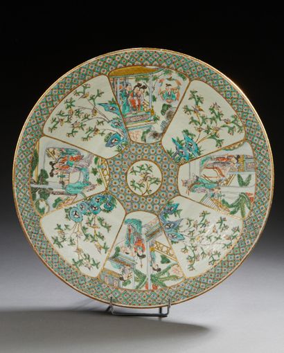 CHINE A circular porcelain dish decorated in polychrome enamels with figures in gardens...