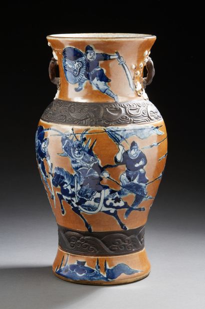 CHINE (NANKIN) A brown porcelain baluster vase decorated in blue with horsemen and...
