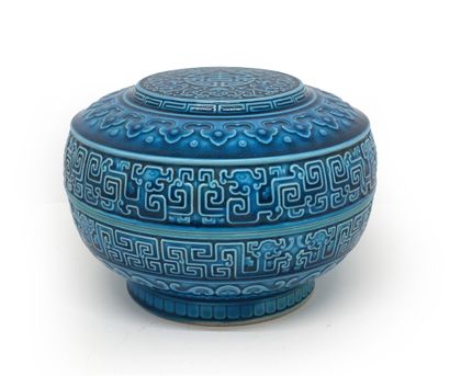 CHINE Circular porcelain box with turquoise glaze and decorated in light relief with...