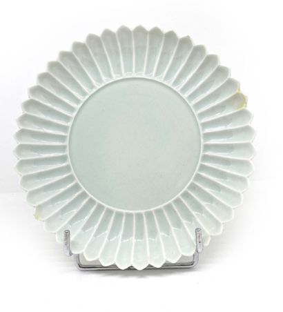 CHINE Circular porcelain bowl, the border formed of flower petals enamelled white.
On...