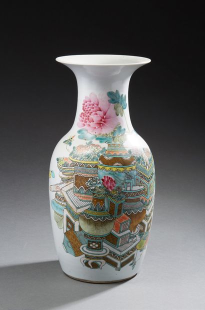 CHINE A baluster-shaped porcelain vase decorated in Famille Rose enamels with vases...