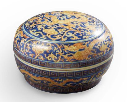 CHINE A circular covered box with a blue background decorated in iron red with pentadactyl...
