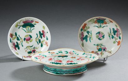 CHINE A porcelain cup and two saucers decorated with flowers in Famille Rose enamels
Republic...