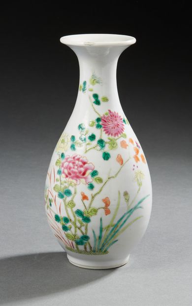 CHINE A small baluster-shaped porcelain vase decorated in Famille Rose enamels with...