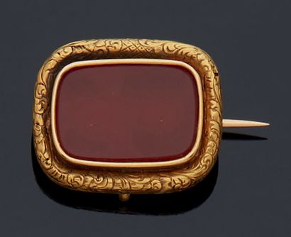 null A 750 mm yellow gold revers pin with a cabochon of carnelian set in a frame...