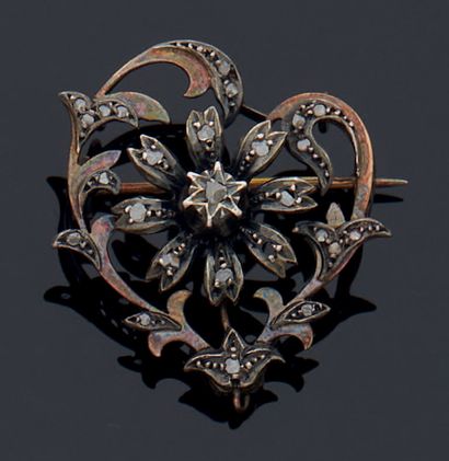 null Heart-shaped brooch in gold 750 mm and silver with flowers set with uncut diamonds...
