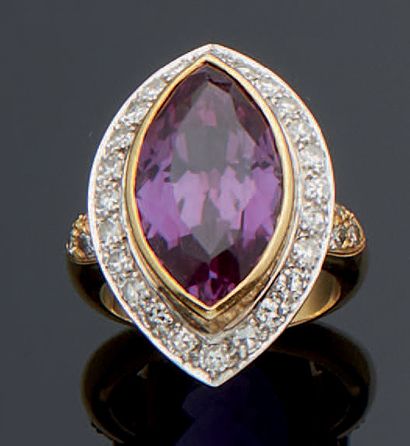 null 
A two-tone gold ring, the head set with a synthetic stone in imitation of amethyst,...