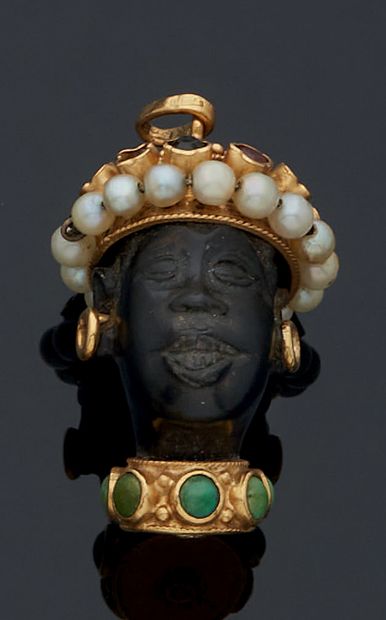 null 
A carved Moorish head pendant in stained bone and gold 750 mm, with earrings,...