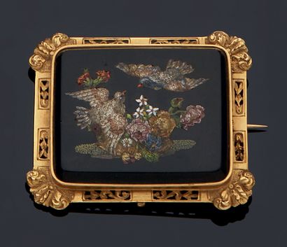 null A gold frame brooch set with a micromosaic miniature showing a scene of birds...