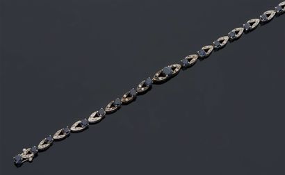 null LINE BRACELET in white gold 750 mm decorated with a river of small round sapphires...