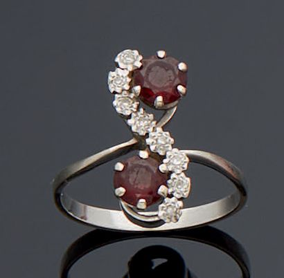 null YOU AND ME RING in white gold, set with two round garnets (worn) and small eight-eight...