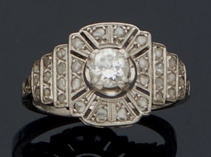 null 850 mm platinum GEOMETRIC RING centered on a half-cut diamond weighing approximately...