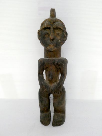 null Sculpture africaine en bois figurant un homme.