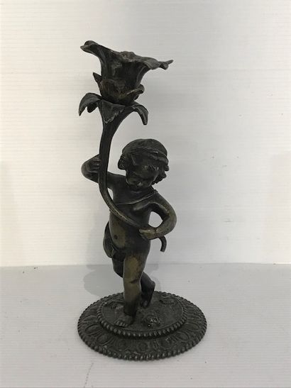 null Bronze candlestick showing a putti. 

Late 19th century. 

(pierced) 

H. :...